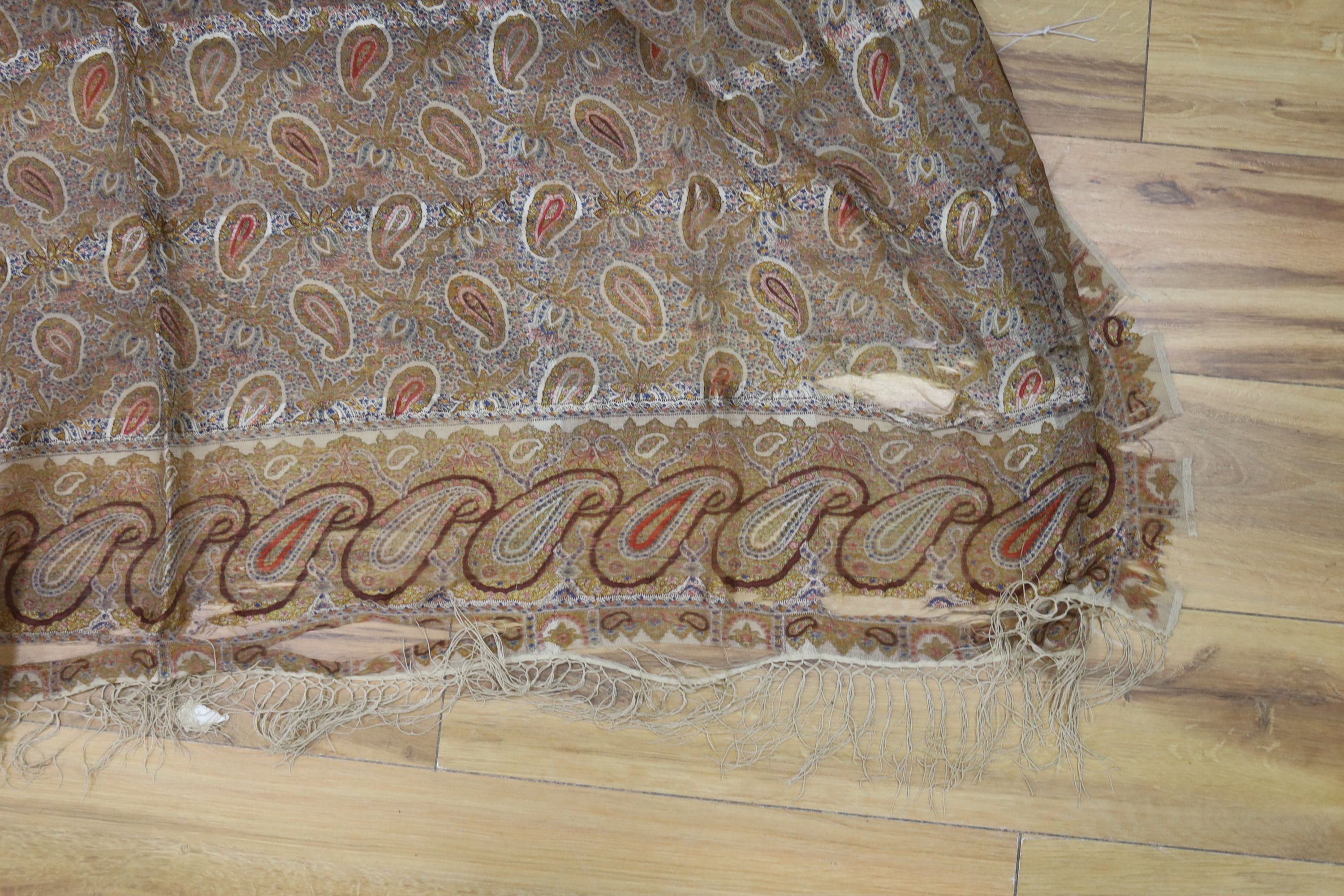 A Paisley pattern silk shaw (damaged) together with two Kelim woven bags (3)